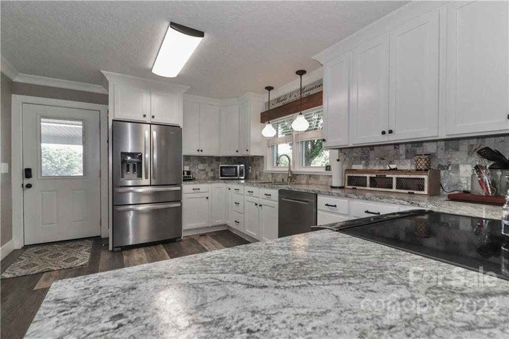 147 Stack Road Olin, NC 28660 - Photo 12 of 47 a kitchen with a refrigerator sink and stainless steel appliances