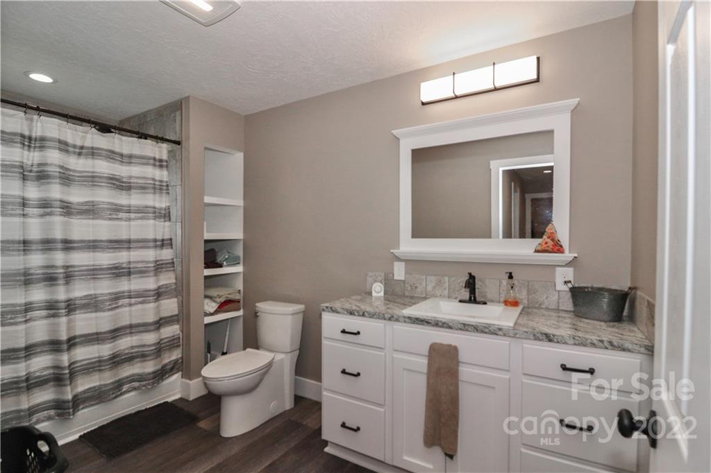 147 Stack Road Olin, NC 28660 - Photo 21 of 47 a bathroom with a granite countertop toilet sink and mirror