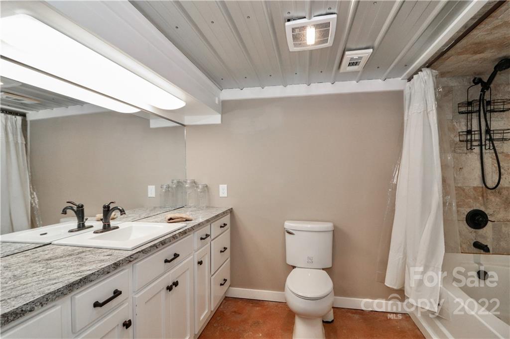 147 Stack Road Olin, NC 28660 - Photo 25 of 47 a bathroom with a granite countertop sink a toilet and a mirror