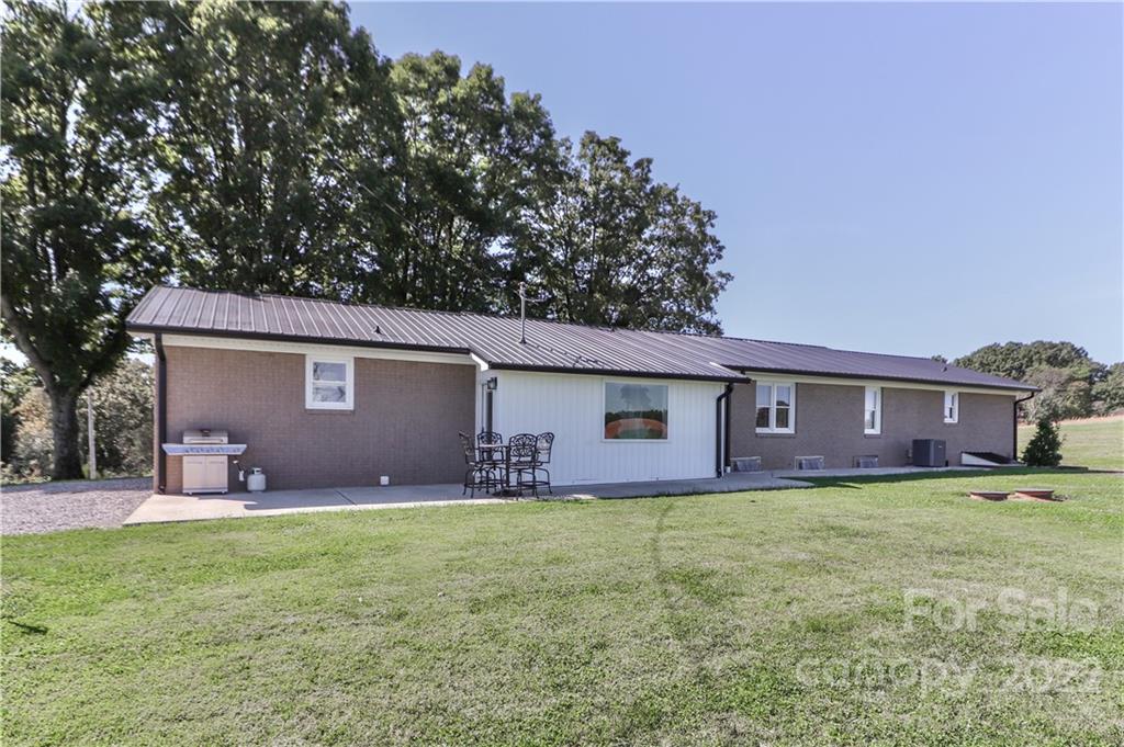 147 Stack Road Olin, NC 28660 - Photo 29 of 47 a front view of house with yard and trees in the background
