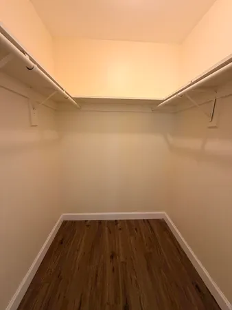 a view of a room with wooden floor