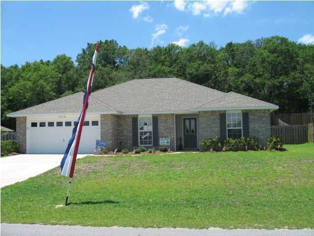 5214 Moore Loop Crestview, FL 32536 - Photo 1 of 13 a aerial view of a house next to a big yard and large trees