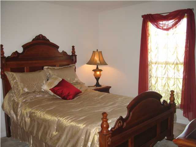 5214 Moore Loop Crestview, FL 32536 - Photo 11 of 13 a bedroom with a bed and window
