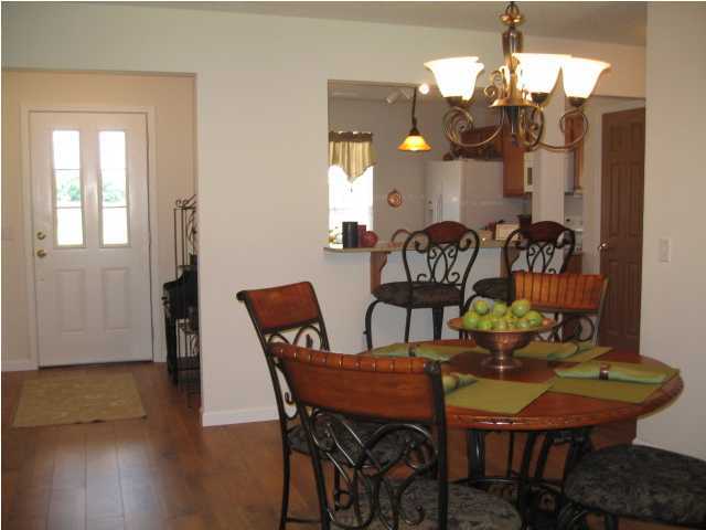 5214 Moore Loop Crestview, FL 32536 - Photo 4 of 13 a view of a dining room with furniture and wooden floor