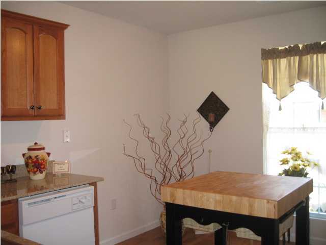 5214 Moore Loop Crestview, FL 32536 - Photo 9 of 13 a dining room with table and flowerpot