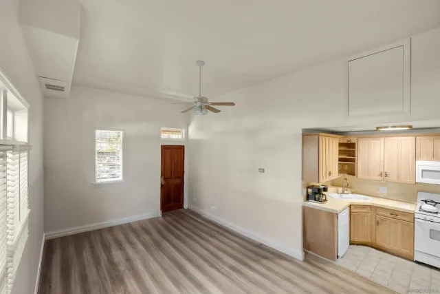 a view of a kitchen with a sink dishwasher and a window