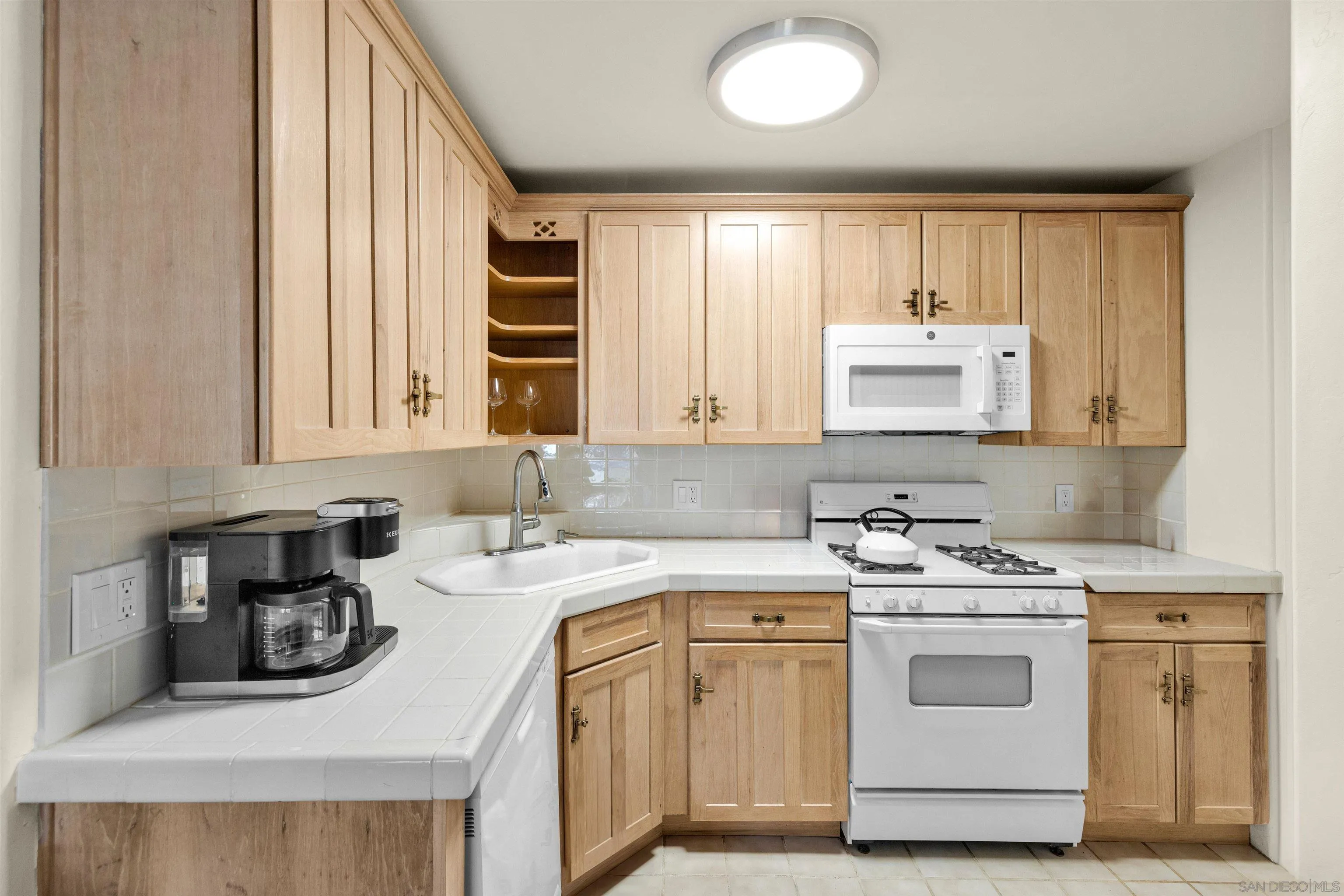 2015 2nd Street, Unit 2015 Julian, CA 92036 - Photo 2 of 11 a kitchen with a sink stove and cabinets