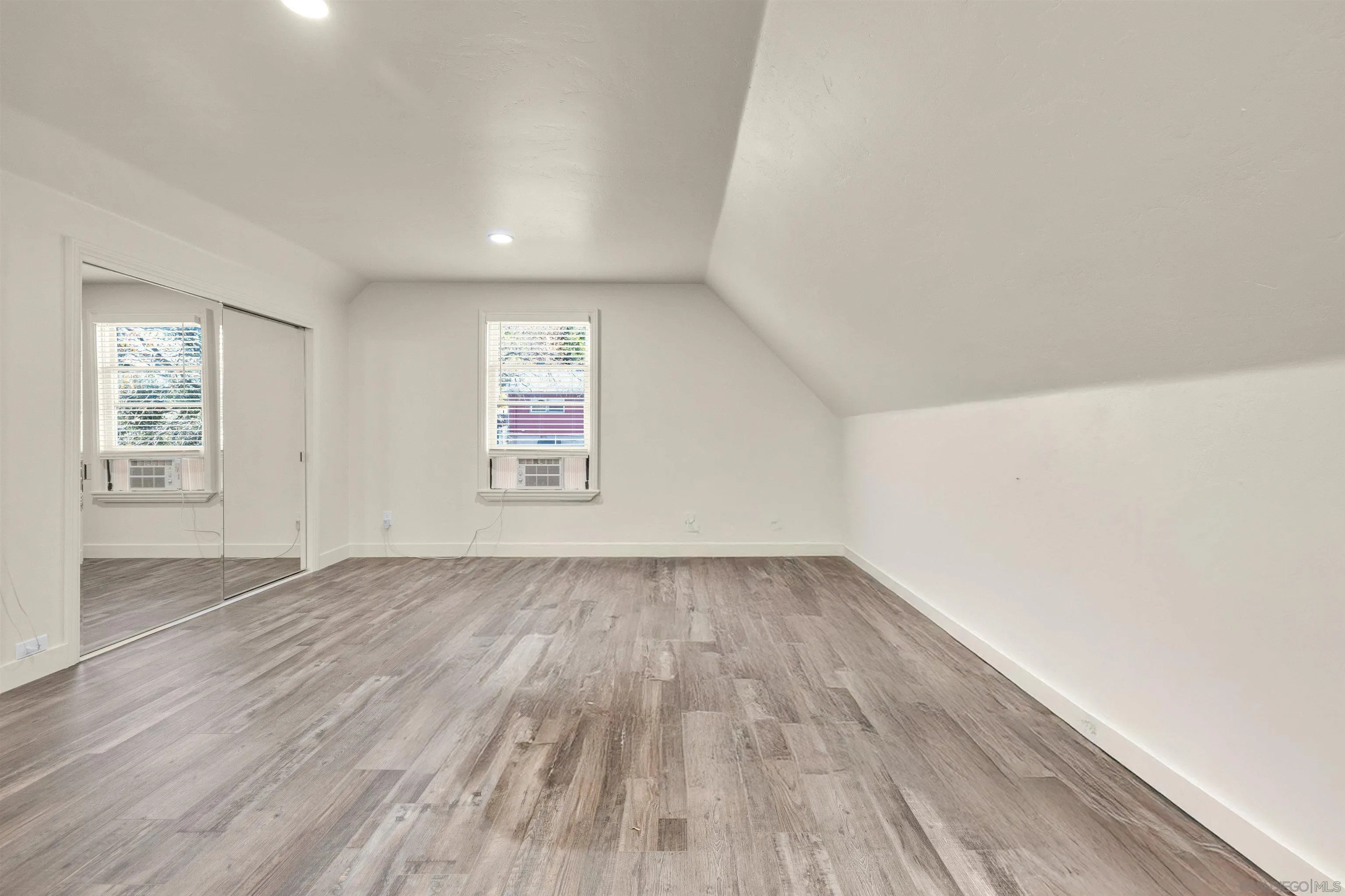 2015 2nd Street, Unit 2015 Julian, CA 92036 - Photo 8 of 11 an empty room with wooden floor and windows