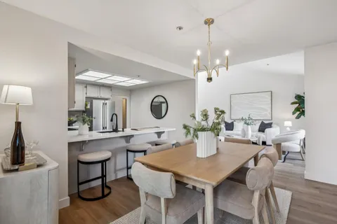 a view of a dining room with furniture and chandelier