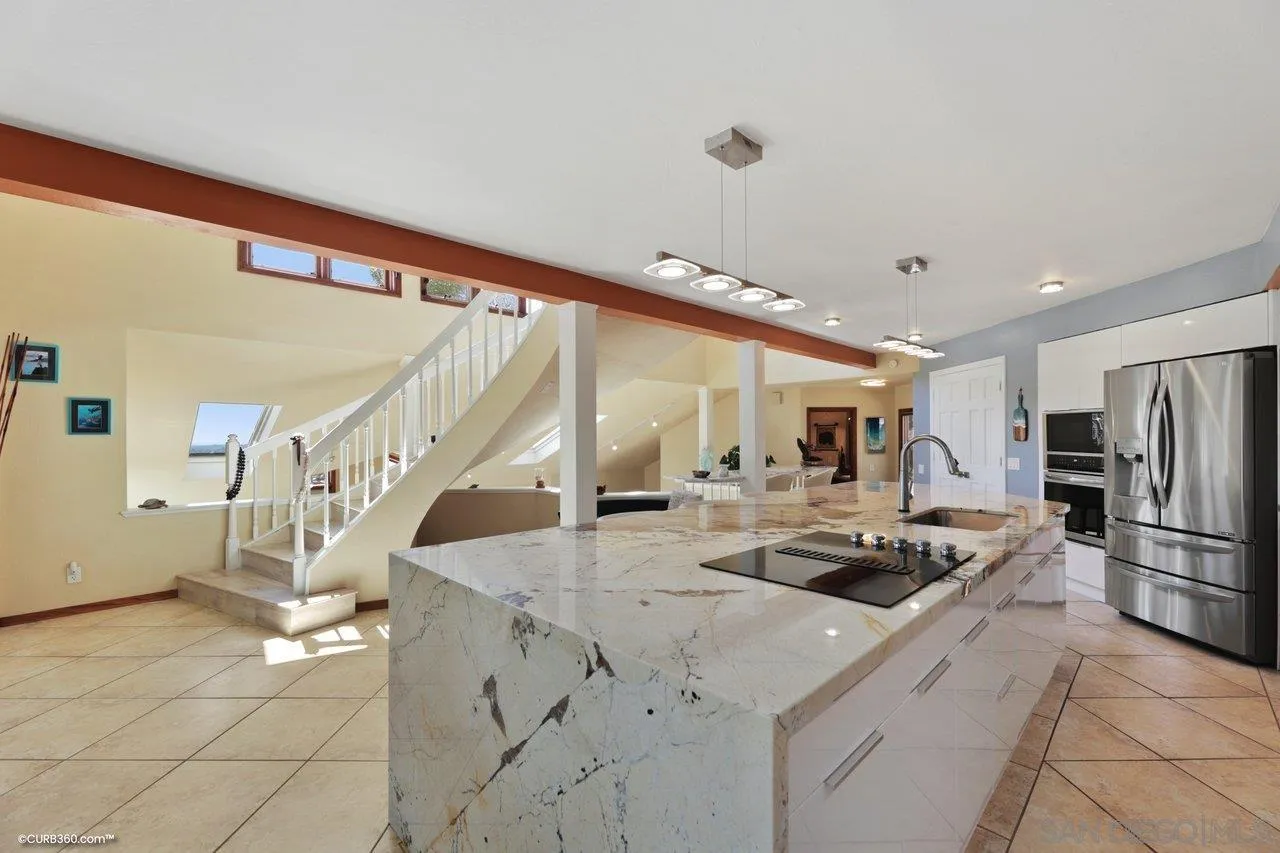 1778 Kings Road Vista, CA 92084 - Photo 21 of 49 a kitchen with stainless steel appliances kitchen island granite countertop a sink and cabinets