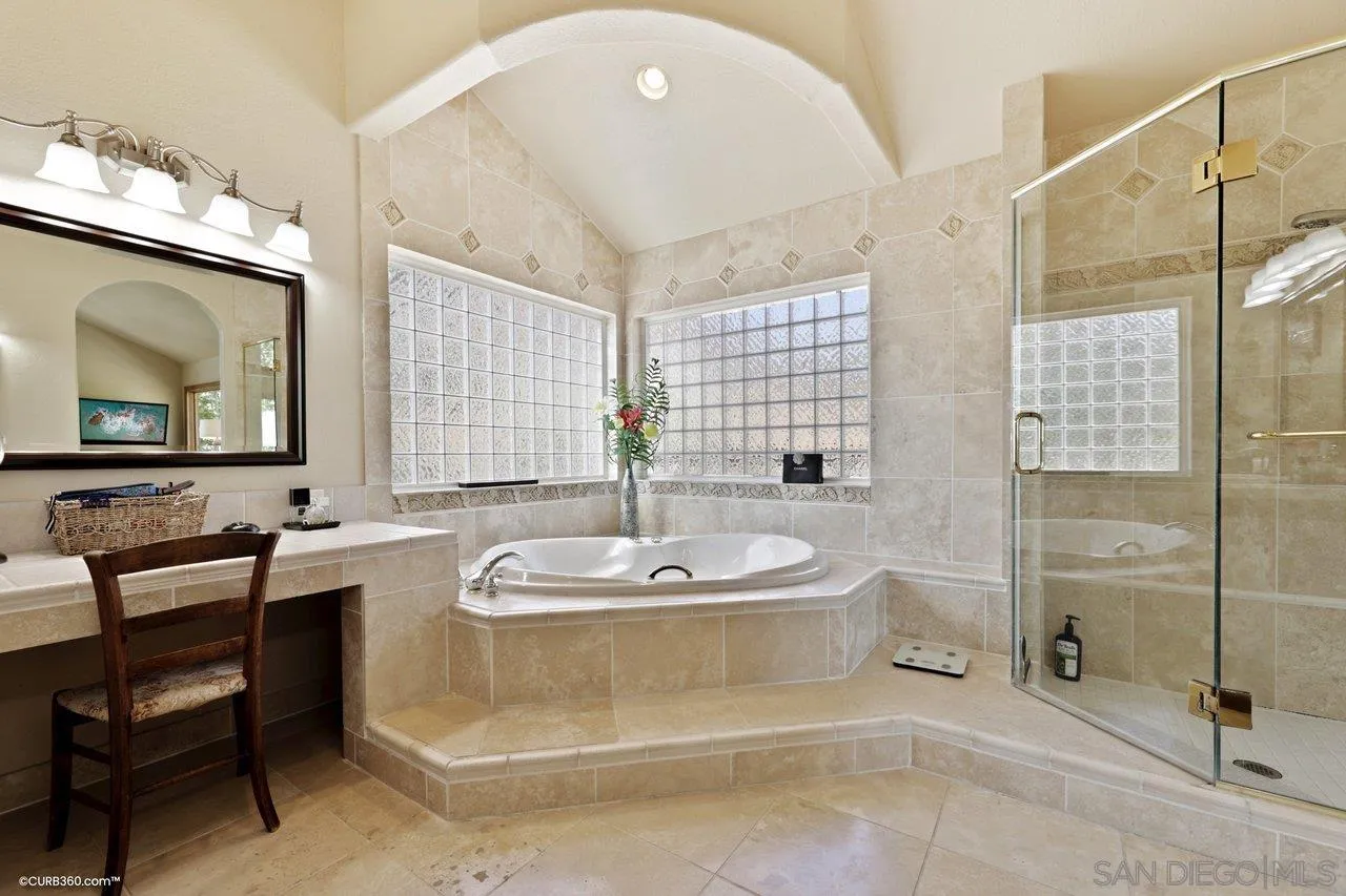 1778 Kings Road Vista, CA 92084 - Photo 27 of 49 a spacious bathroom with a double vanity sink a mirror and a bathtub