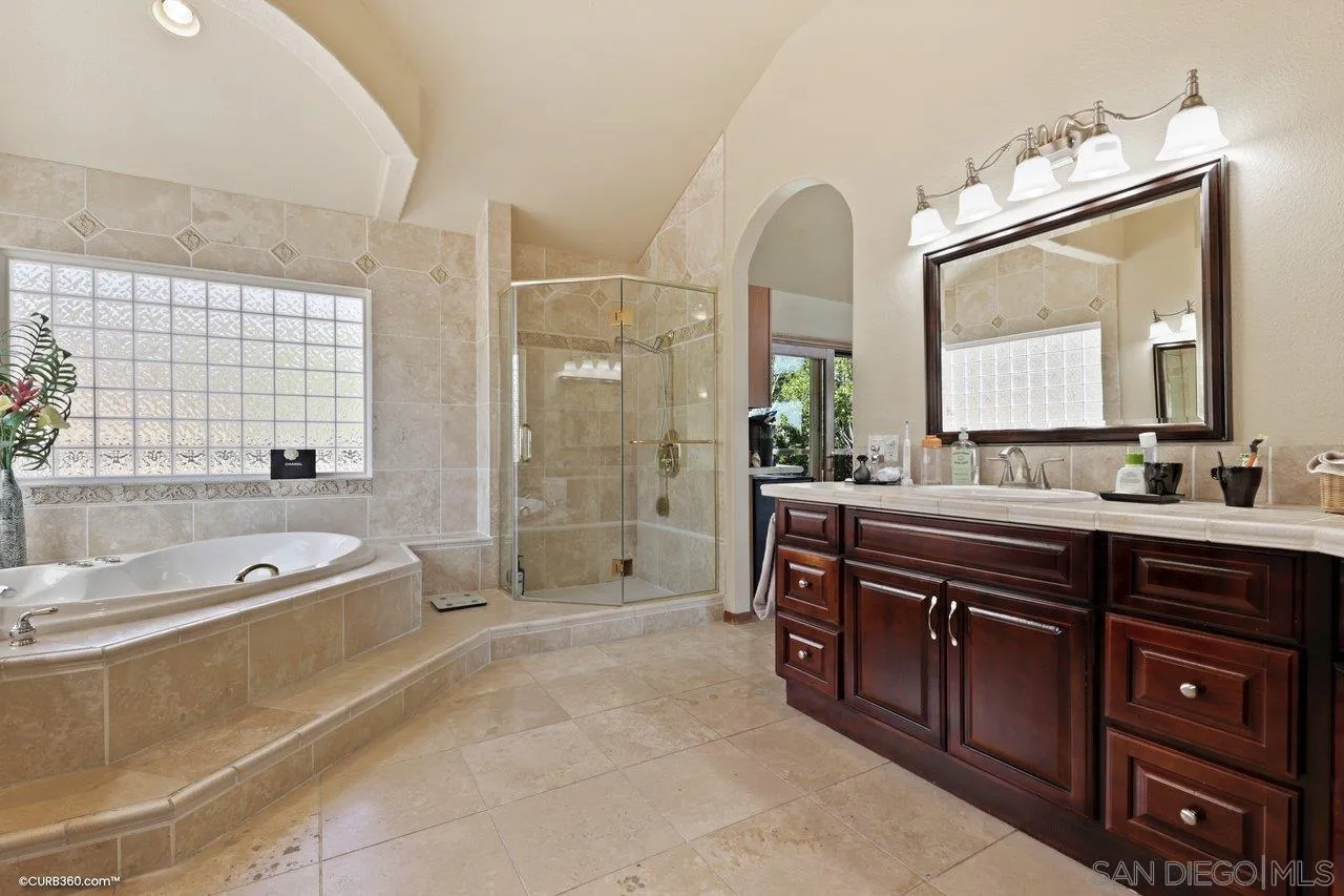 1778 Kings Road Vista, CA 92084 - Photo 28 of 49 a spacious bathroom with a tub sink and mirror