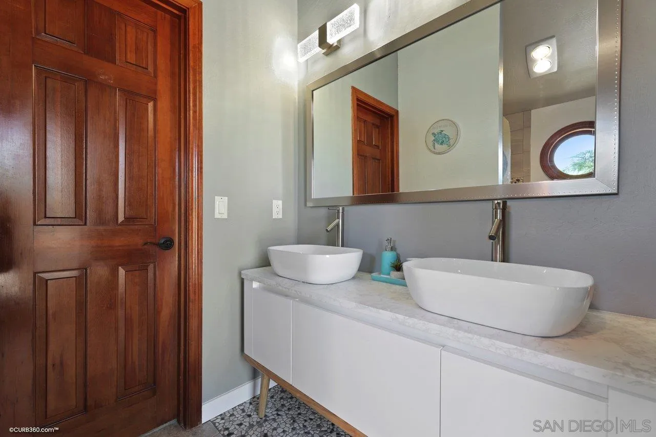 1778 Kings Road Vista, CA 92084 - Photo 38 of 49 a bathroom with a sink and a mirror