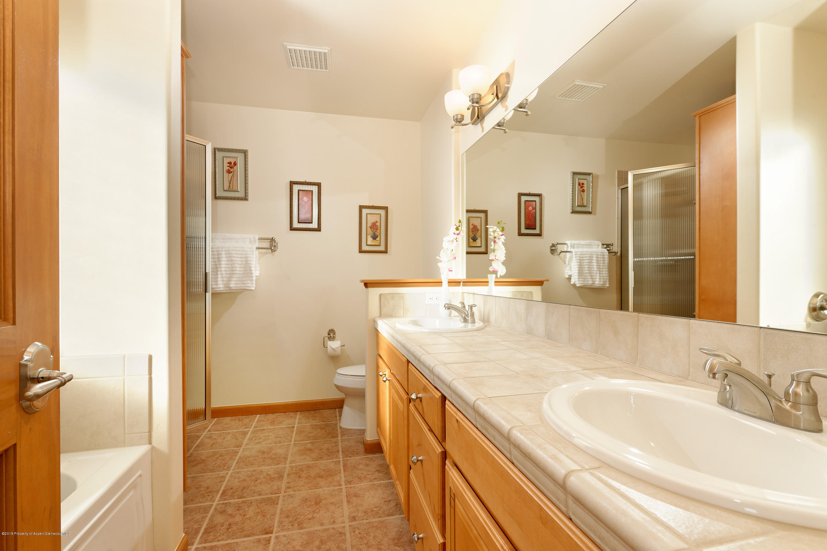 1939 Promontory Circle Rifle, CO 81650 - Photo 10 of 14 a bathroom with a granite countertop sink mirror and a
