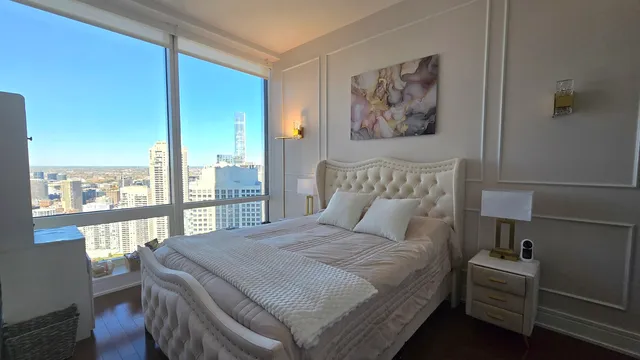 a bedroom with a large bed and a large window