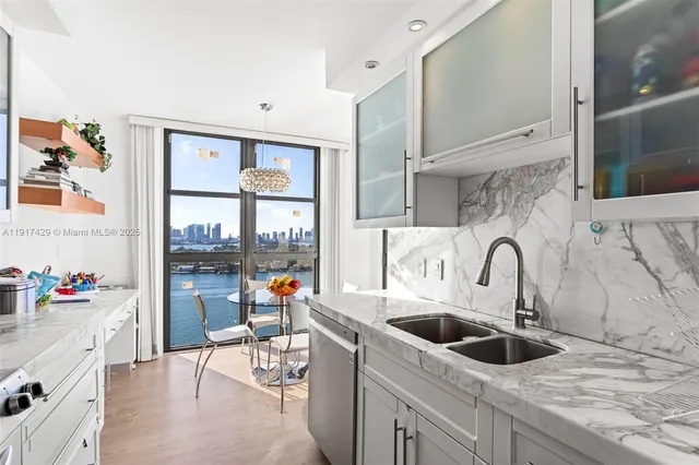 a kitchen with stainless steel appliances a sink and a stove top oven
