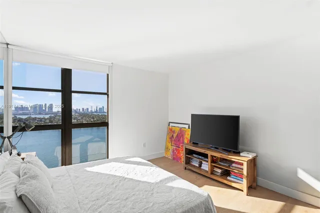 a bathroom with a granite countertop sink mirror and shower