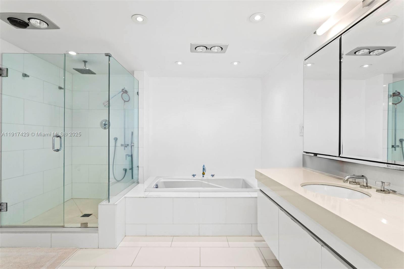 9 Island Avenue, Unit 2006 Miami Beach, FL 33139 - Photo 19 of 24 a bathroom with a granite countertop sink mirror and shower
