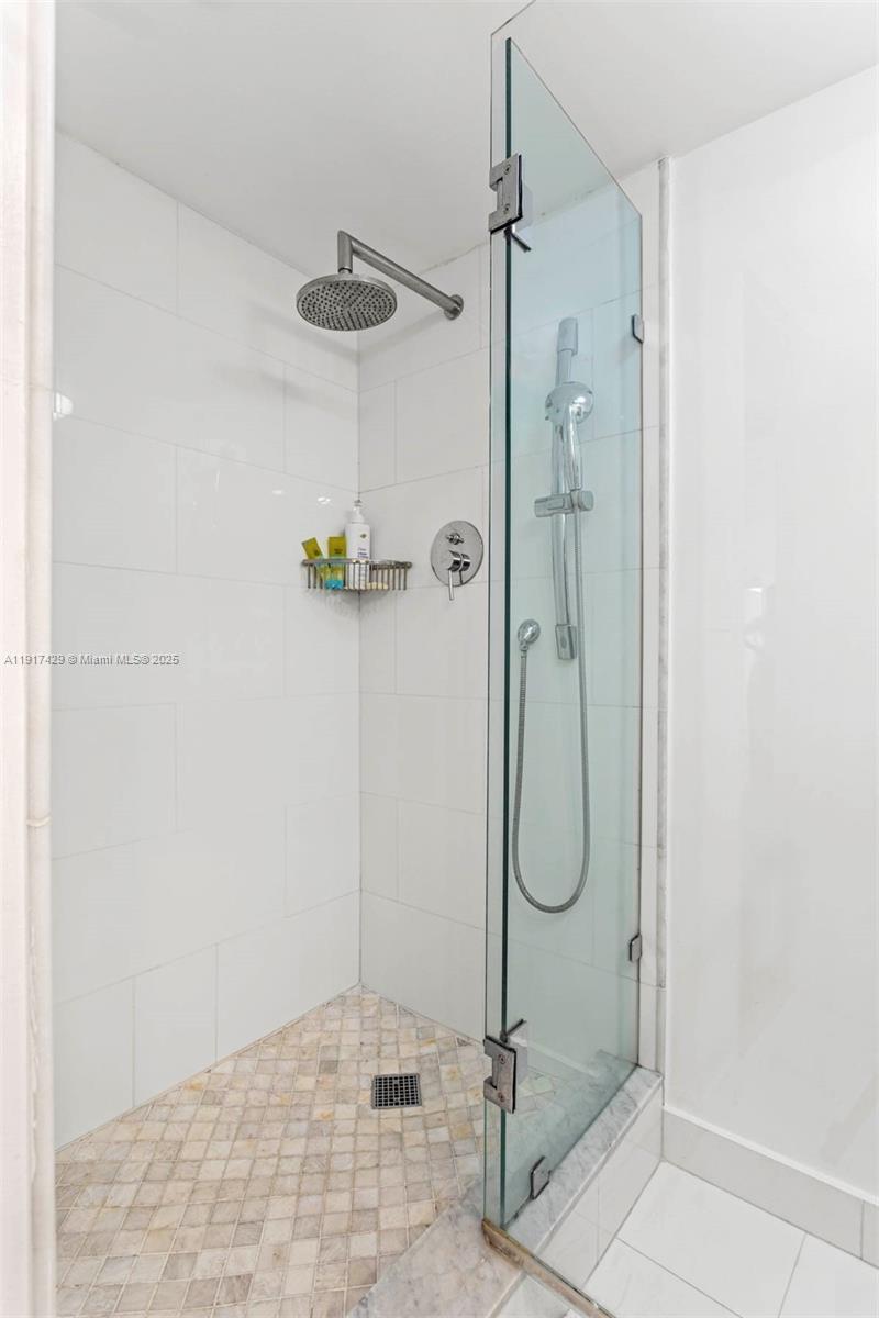 9 Island Avenue, Unit 2006 Miami Beach, FL 33139 - Photo 23 of 24 a bathroom with a glass shower door