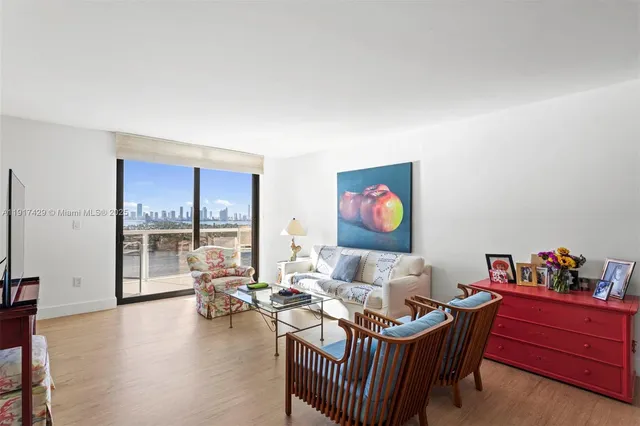 a living room with furniture and floor to ceiling window