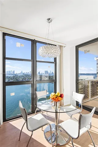 a living room with furniture and a floor to ceiling window