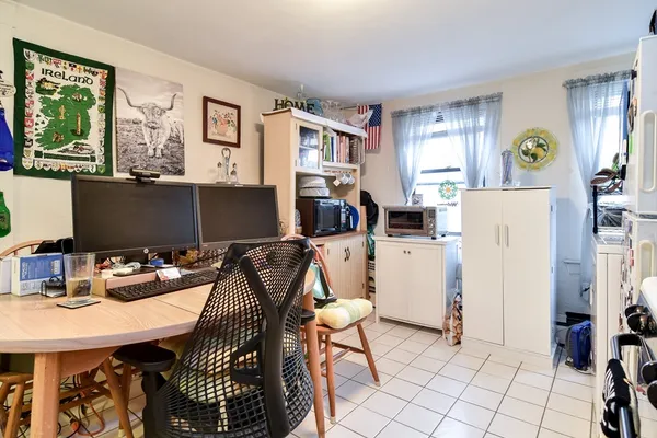 a room with a large window and refrigerator