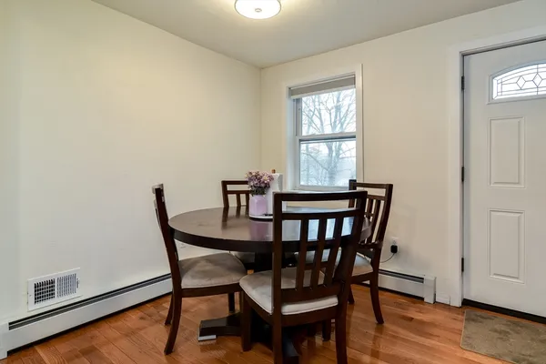 a view of a dining room with furniture window and wooden floor