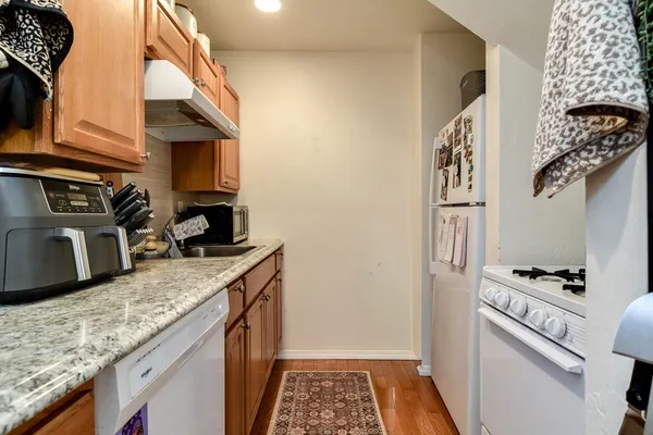 a kitchen with a refrigerator and a stove top oven