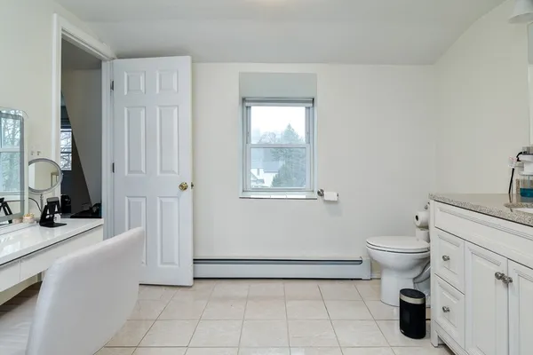 a bathroom with a sink a toilet and a mirror