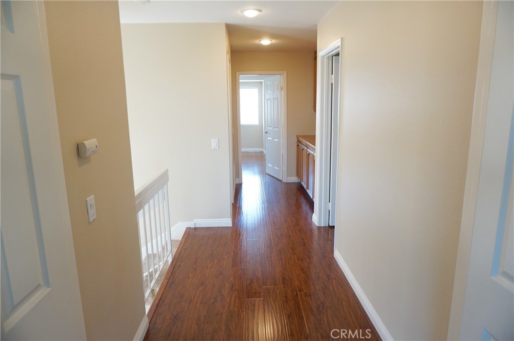 19584 Shadow Glen Circle Porter Ranch, CA 91326 - Photo 32 of 72 a view of a hallway with wooden floor