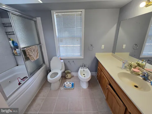 a spacious bathroom with a double vanity sink and a mirror
