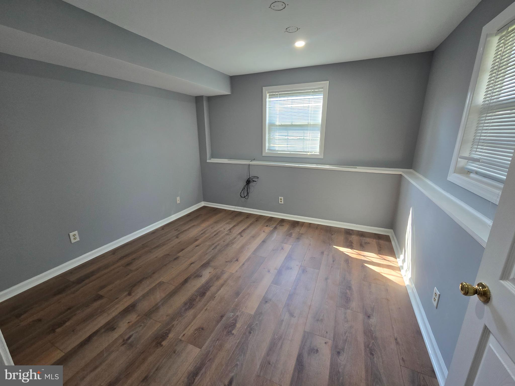 11 Hockamick Road Cookstown, NJ 08511 - Photo 18 of 45 an empty room with wooden floor and windows