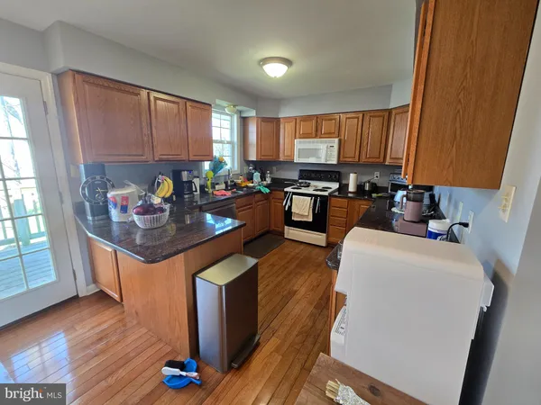 a kitchen with stainless steel appliances granite countertop a stove refrigerator sink and cabinets