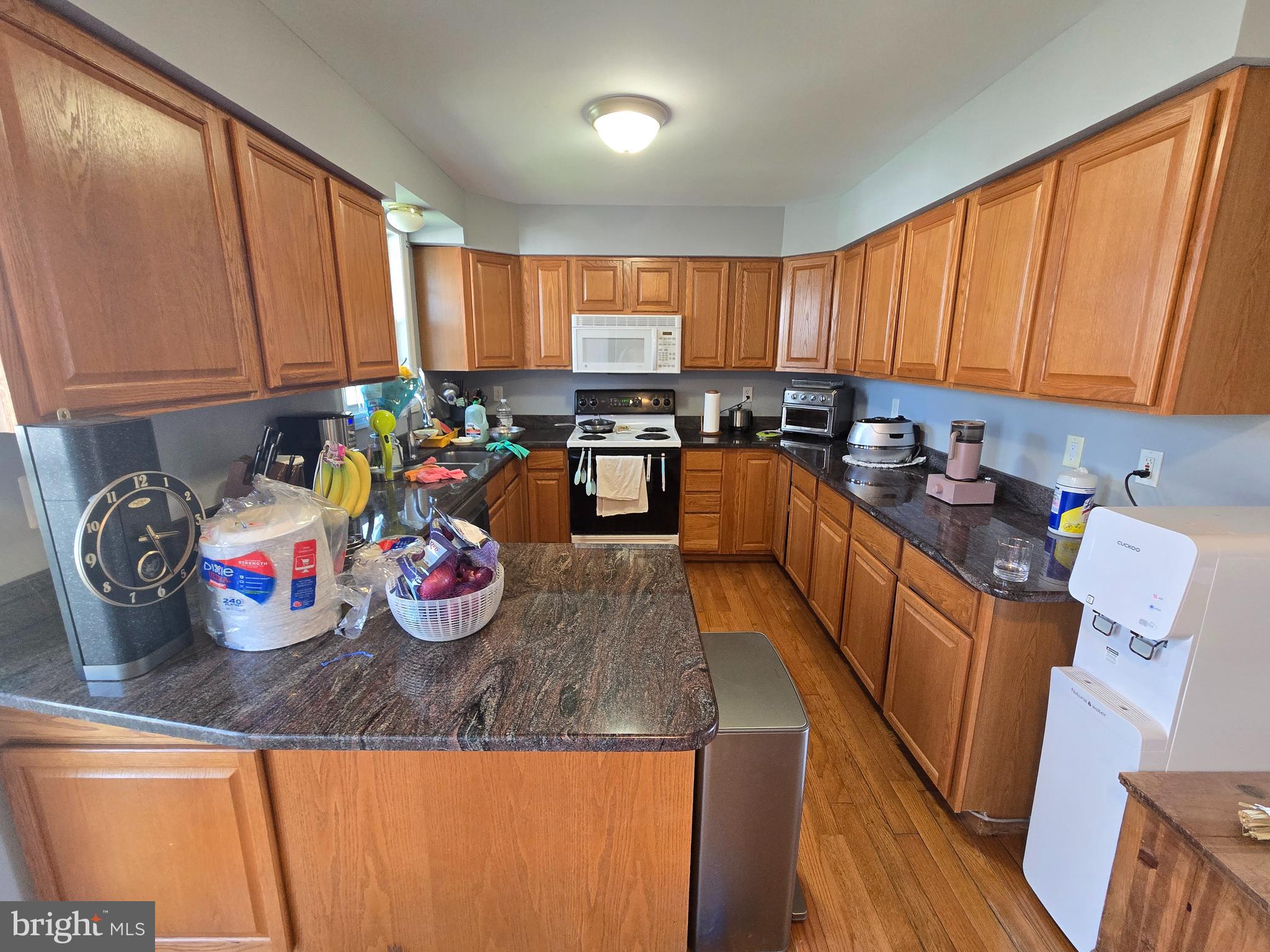 11 Hockamick Road Cookstown, NJ 08511 - Photo 20 of 45 a kitchen with granite countertop lots of clutter and stainless steel appliances
