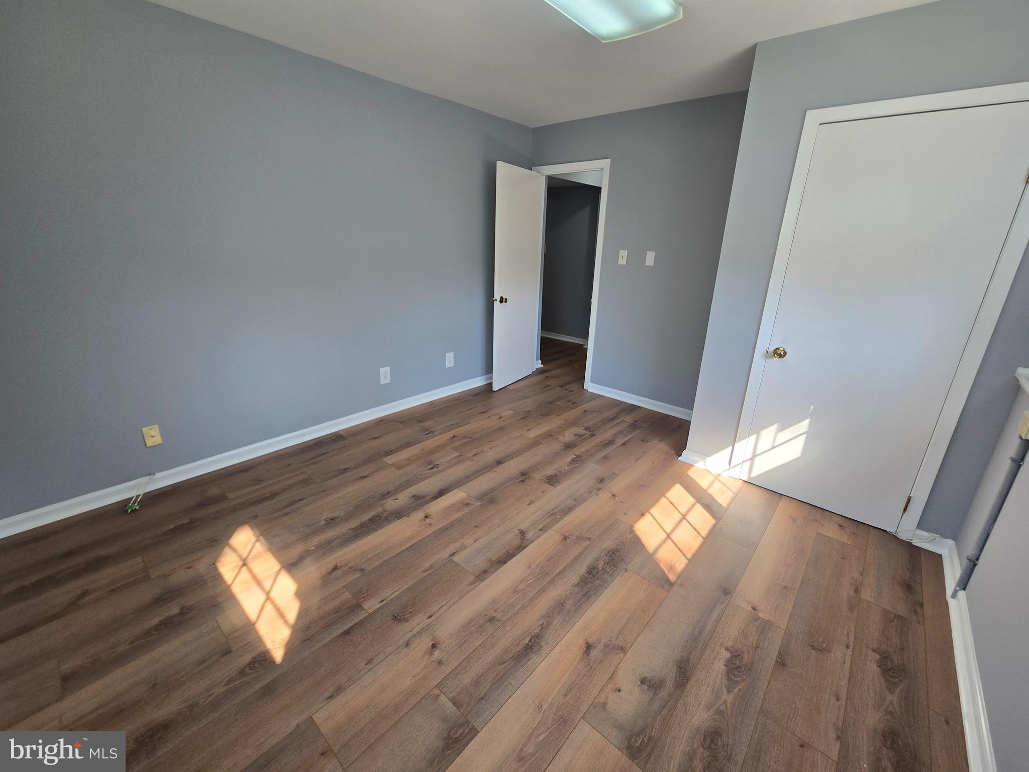 11 Hockamick Road Cookstown, NJ 08511 - Photo 26 of 45 a view of empty room with wooden floor and window