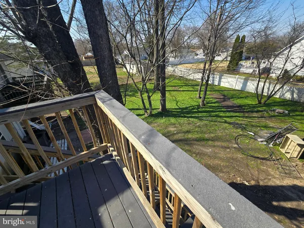 a view of a wooden deck next to a yard