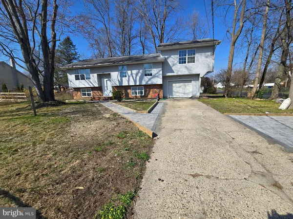 a view of a house with wooden fence