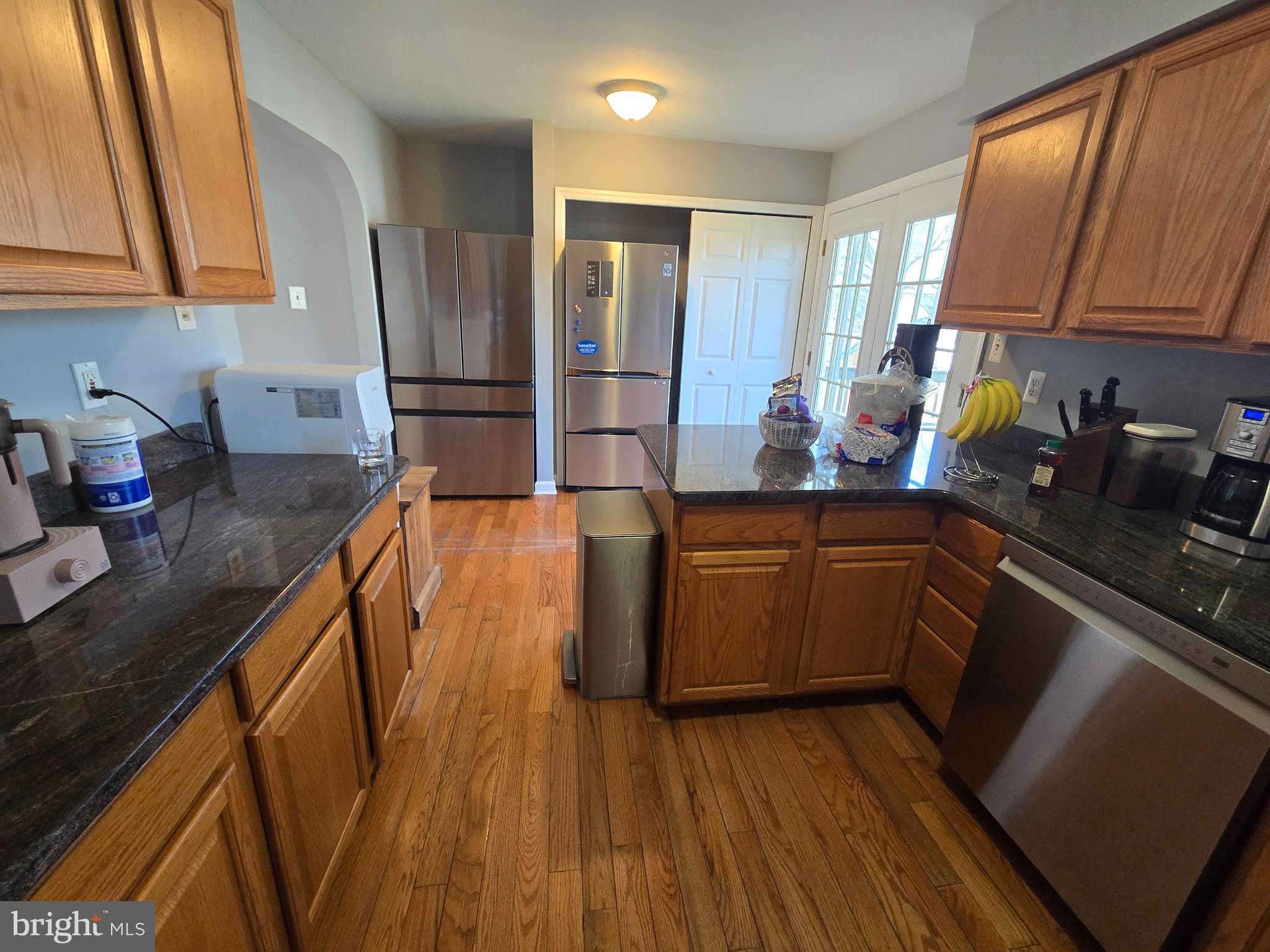 11 Hockamick Road Cookstown, NJ 08511 - Photo 4 of 45 a kitchen with wooden floors and wooden cabinets