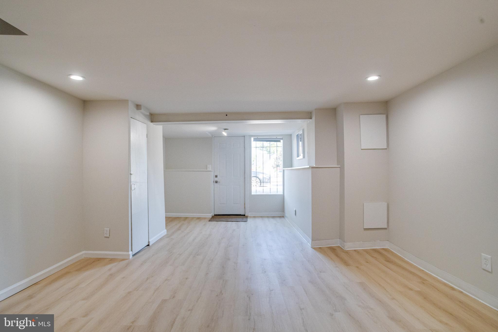 5878 Belair Road Baltimore, MD 21206 - Photo 31 of 41 a view of empty room with wooden floor and window