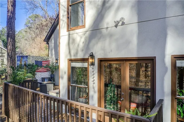 a view of a balcony with wooden floor and fence
