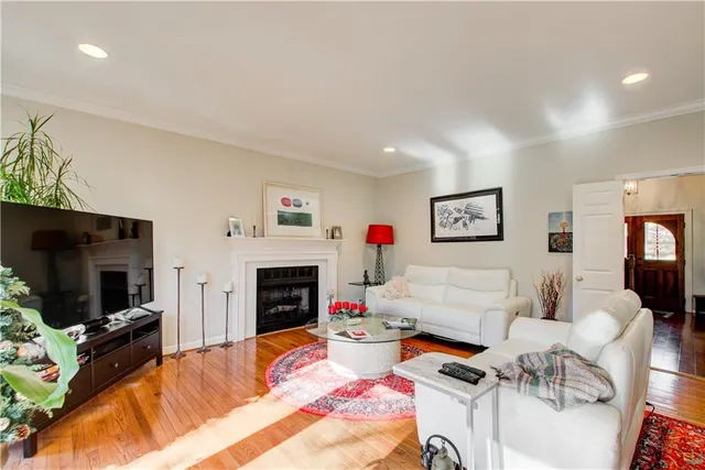 a view of a hallway with wooden floor and windows