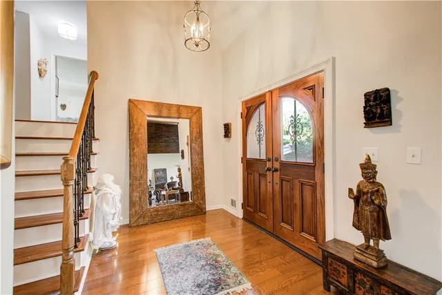 a bedroom with a bed and a flat tv screen on dresser
