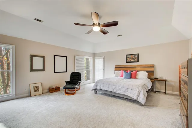 a spacious bathroom with a double vanity sink a mirror and a bathtub