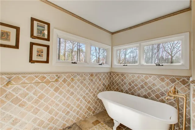 a view of staircase with lots of frames on wall