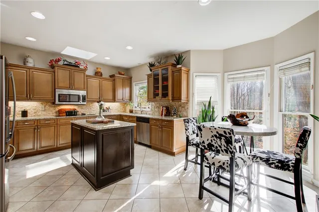 a kitchen with stainless steel appliances a stove a refrigerator and a refrigerator