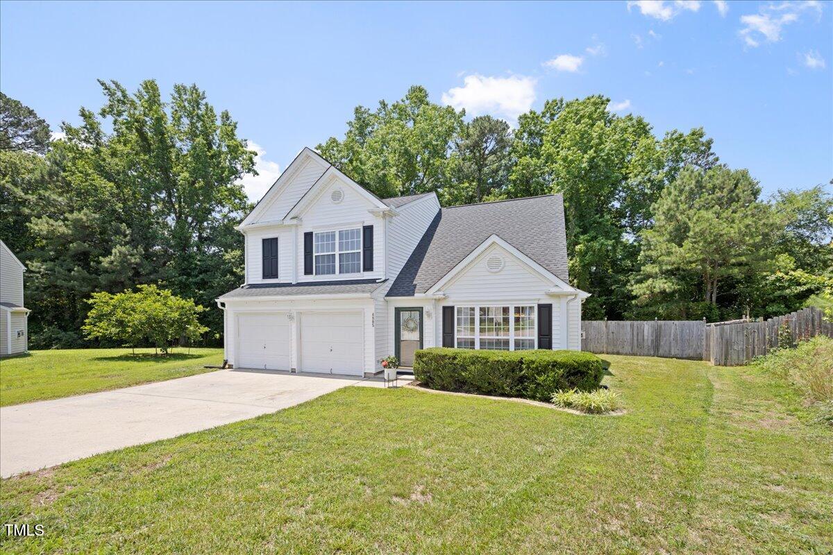4805 Castle Crest Court Raleigh, NC 27616 - Photo 2 of 29 a front view of a house with a garden and yard