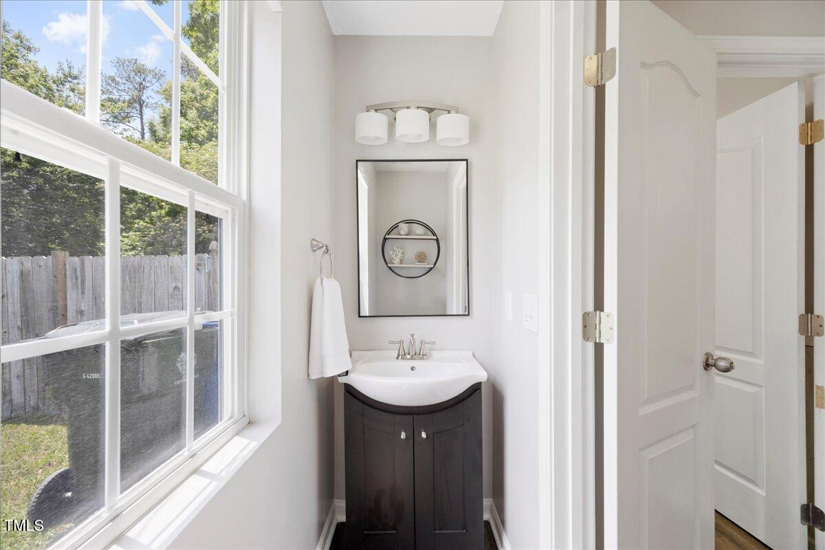 4805 Castle Crest Court Raleigh, NC 27616 - Photo 10 of 29 a bathroom with a sink a mirror and a window