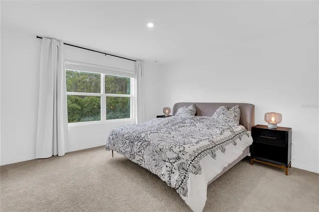 a bedroom with a bed and a view of bathroom
