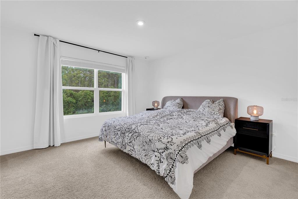 4226 Southern Vista Loop St. Cloud, FL 34772 - Photo 14 of 39 a bedroom with a bed and a window