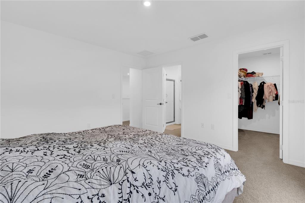 4226 Southern Vista Loop St. Cloud, FL 34772 - Photo 15 of 39 a bedroom with a bed and a view of bathroom